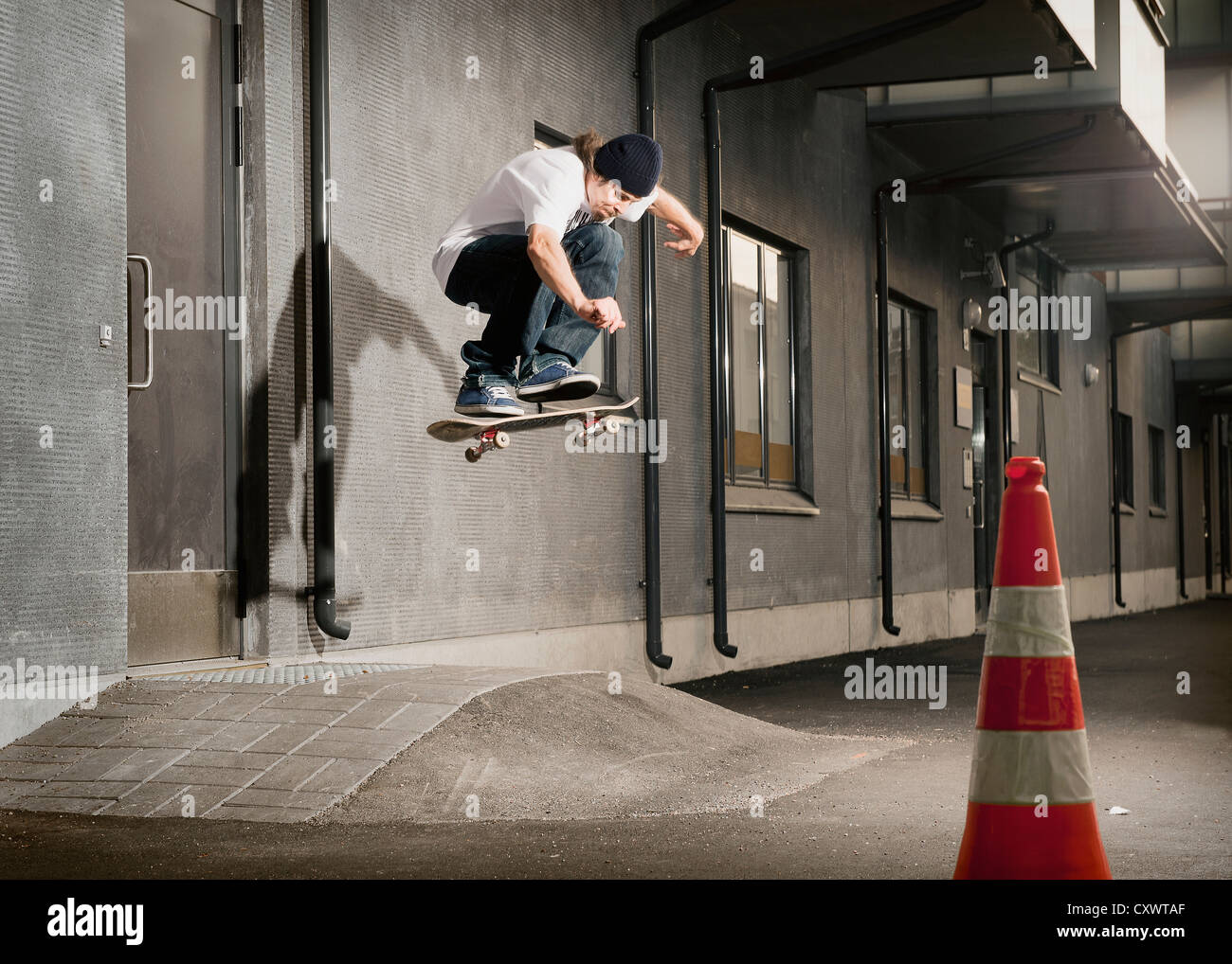 Skater jumping on urban ramp Stock Photo