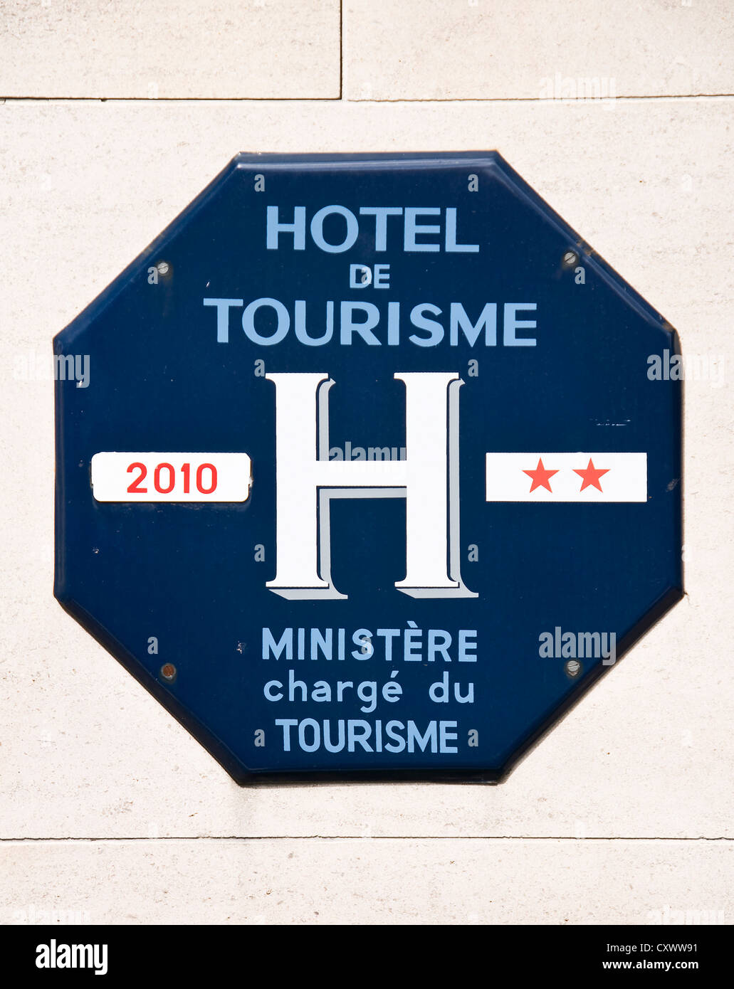 French two stars hotel official sign from the tourism ministry : blue octogon with the text hotel de tourisme Stock Photo