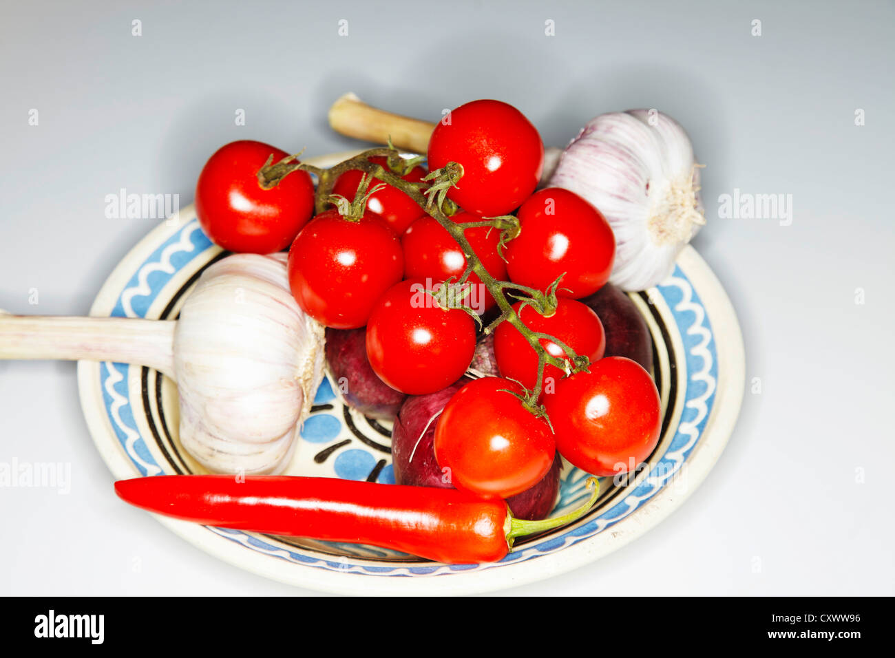 Plate of tomatoes, garlic and chilies Stock Photo