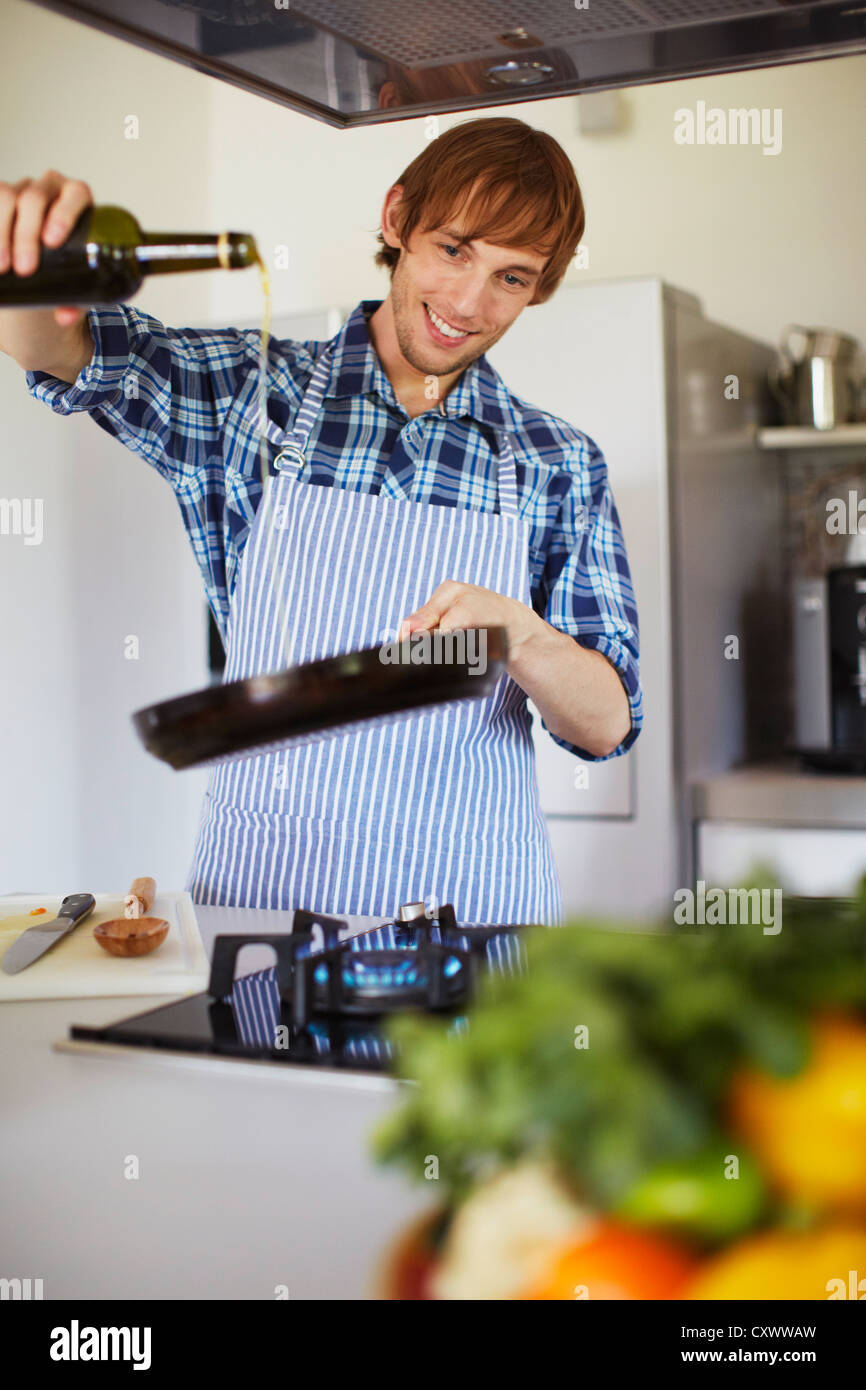 Man cooking with wine in kitchen Stock Photo Alamy