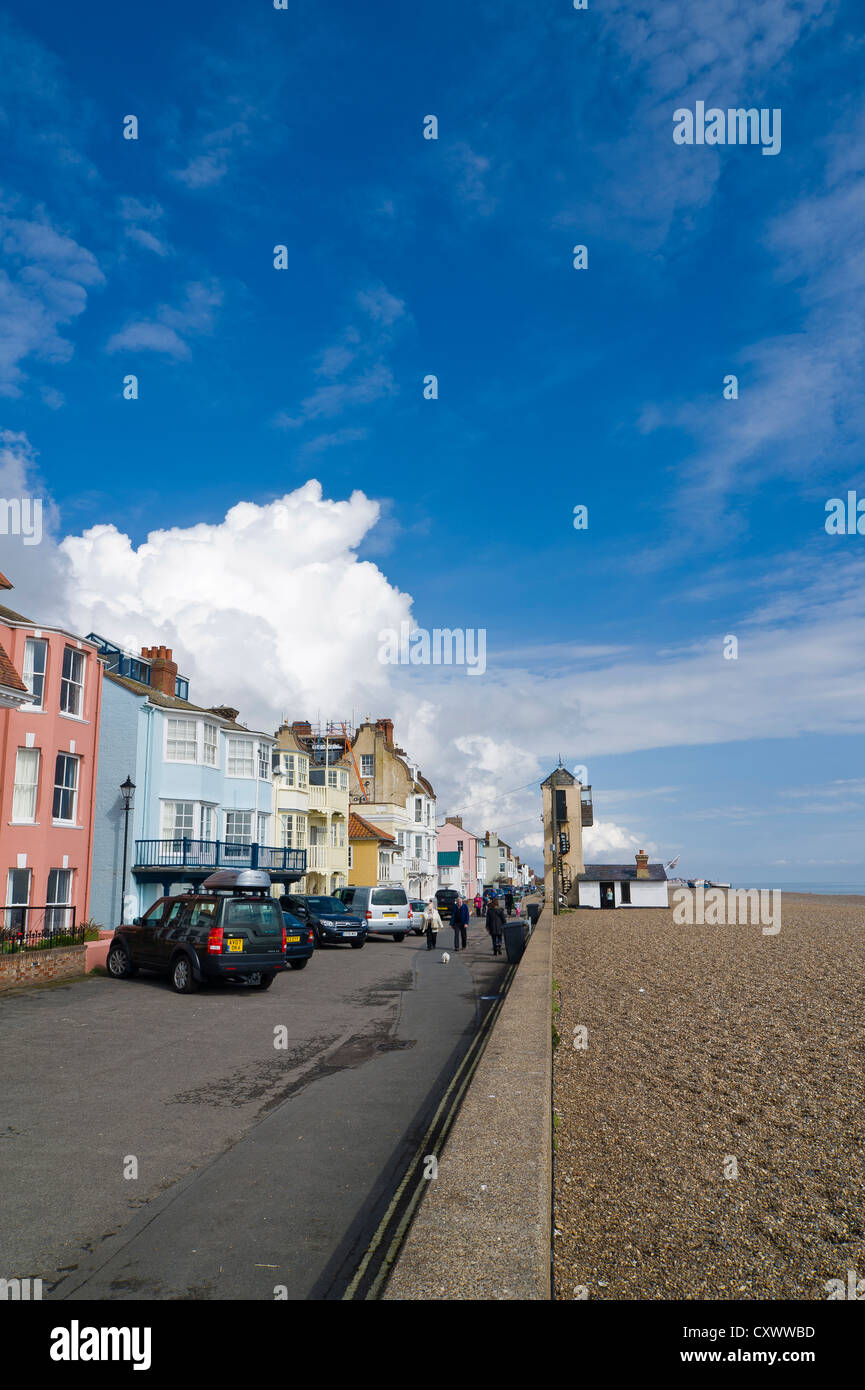 Aldeburgh seafront in Suffolk, England on a sunny day with a big cloud over terraced houses on cragg path. Stock Photo