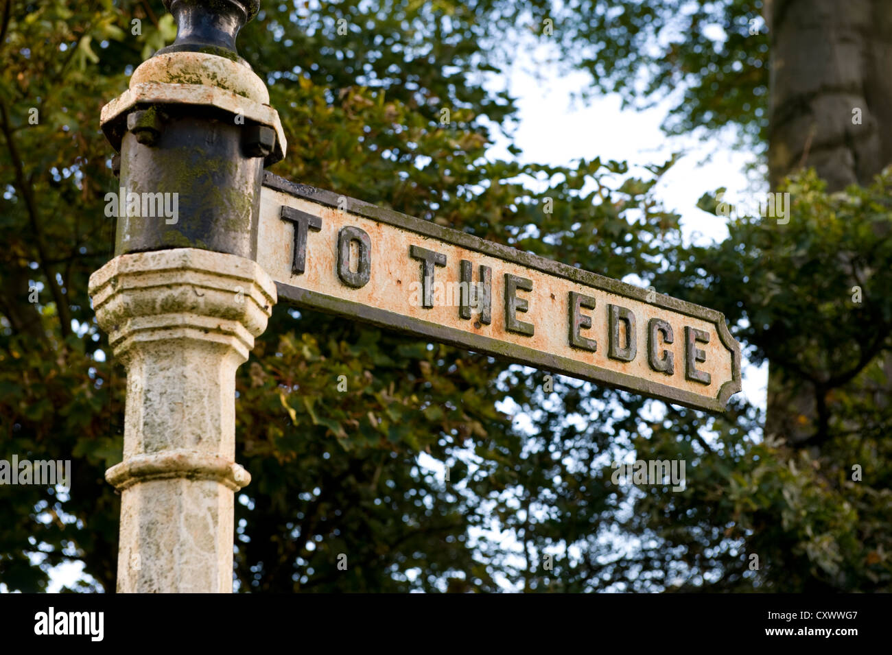 vintage metal roadside signpost at Alderley Edge near stormy point reads 'to the edge' Stock Photo