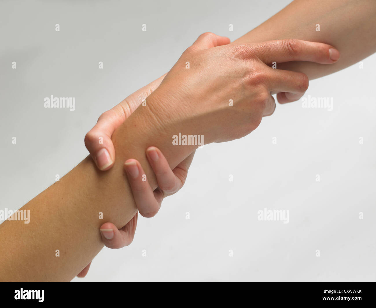 hand shake wrist grab save saving drowning stack hands Stock Photo