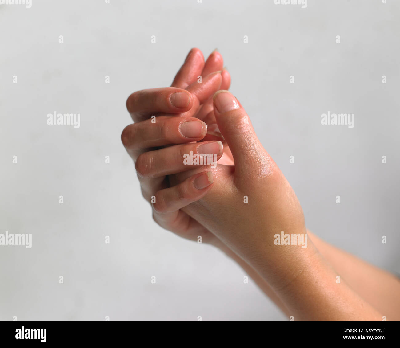 sanitizer  or oil water on their hands Stock Photo