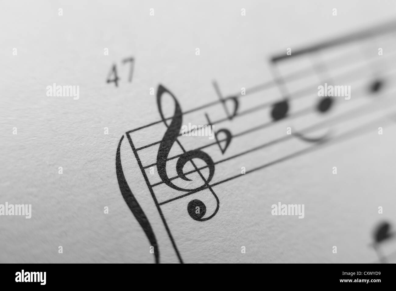 Music sheet notes score melody close up black white lines composition left right hands treble cleft printed on paper Stock Photo