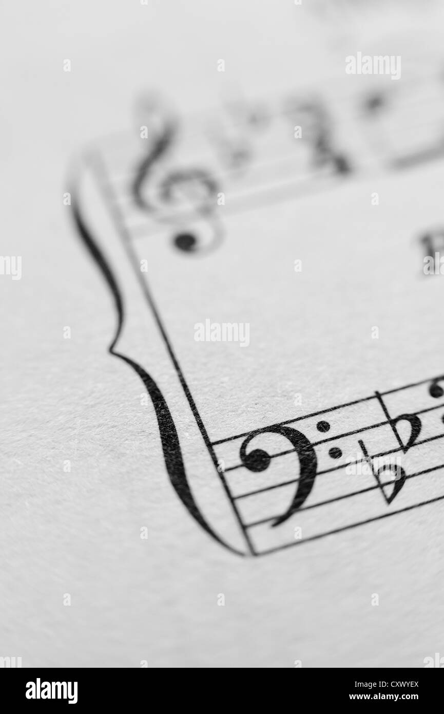 Music sheet notes score melody close up black white lines composition left right hands treble cleft printed on paper Stock Photo