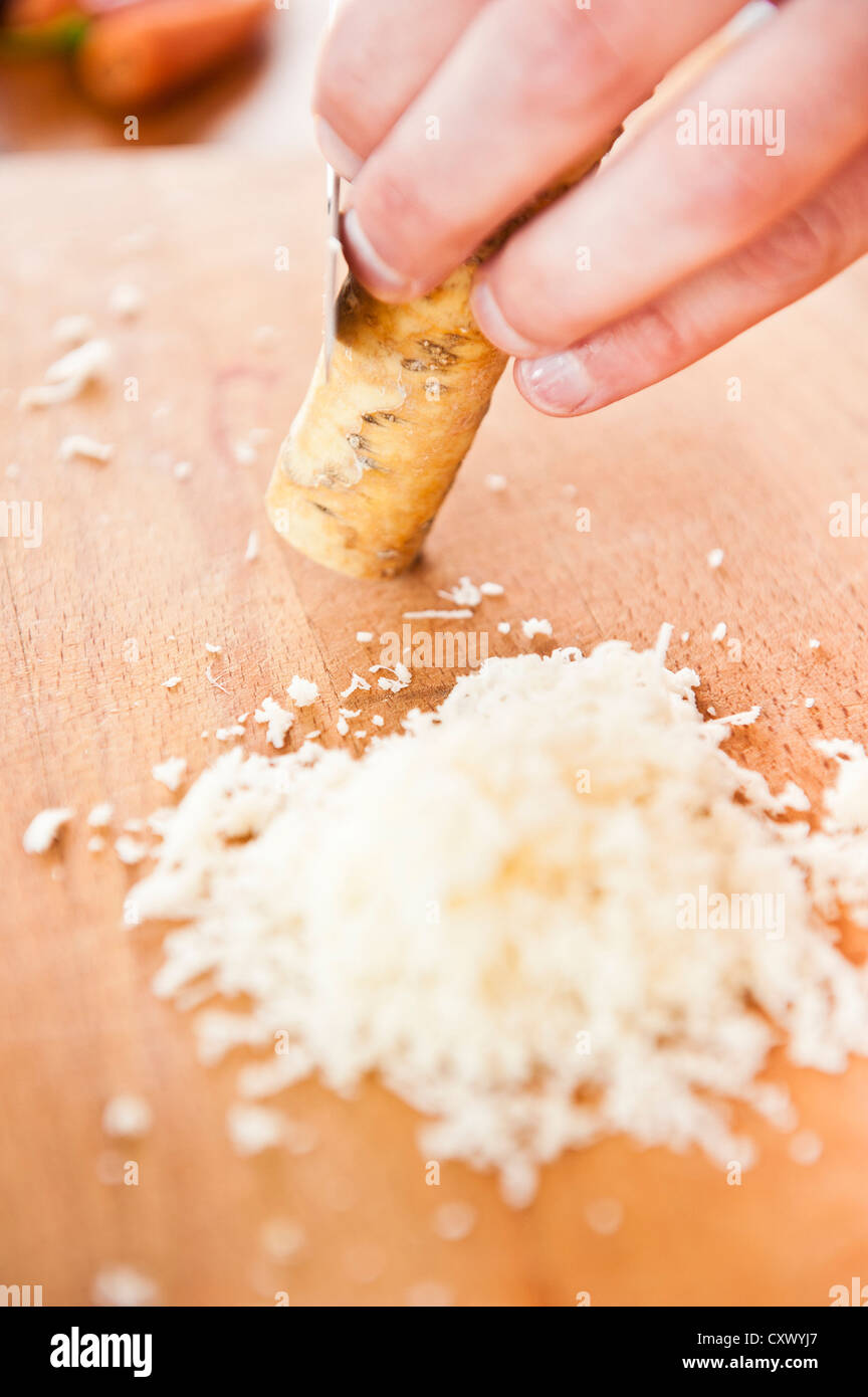 Closeup of horse-radish beeing peeled and grated Stock Photo