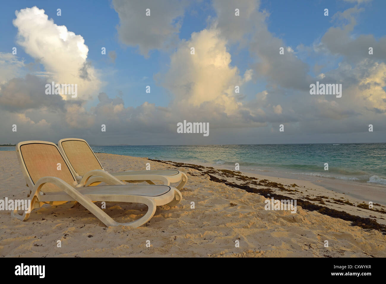 Sun lounger on tropical beach at sunrise, Punta Cana, Dominican Republic Stock Photo