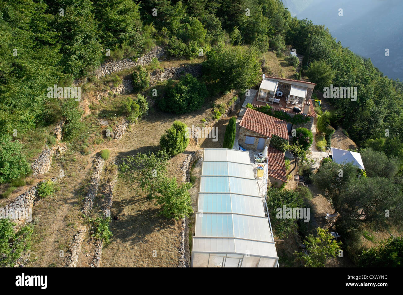 House with a covered swimming pool in the mountains, aerial view, South of France Stock Photo