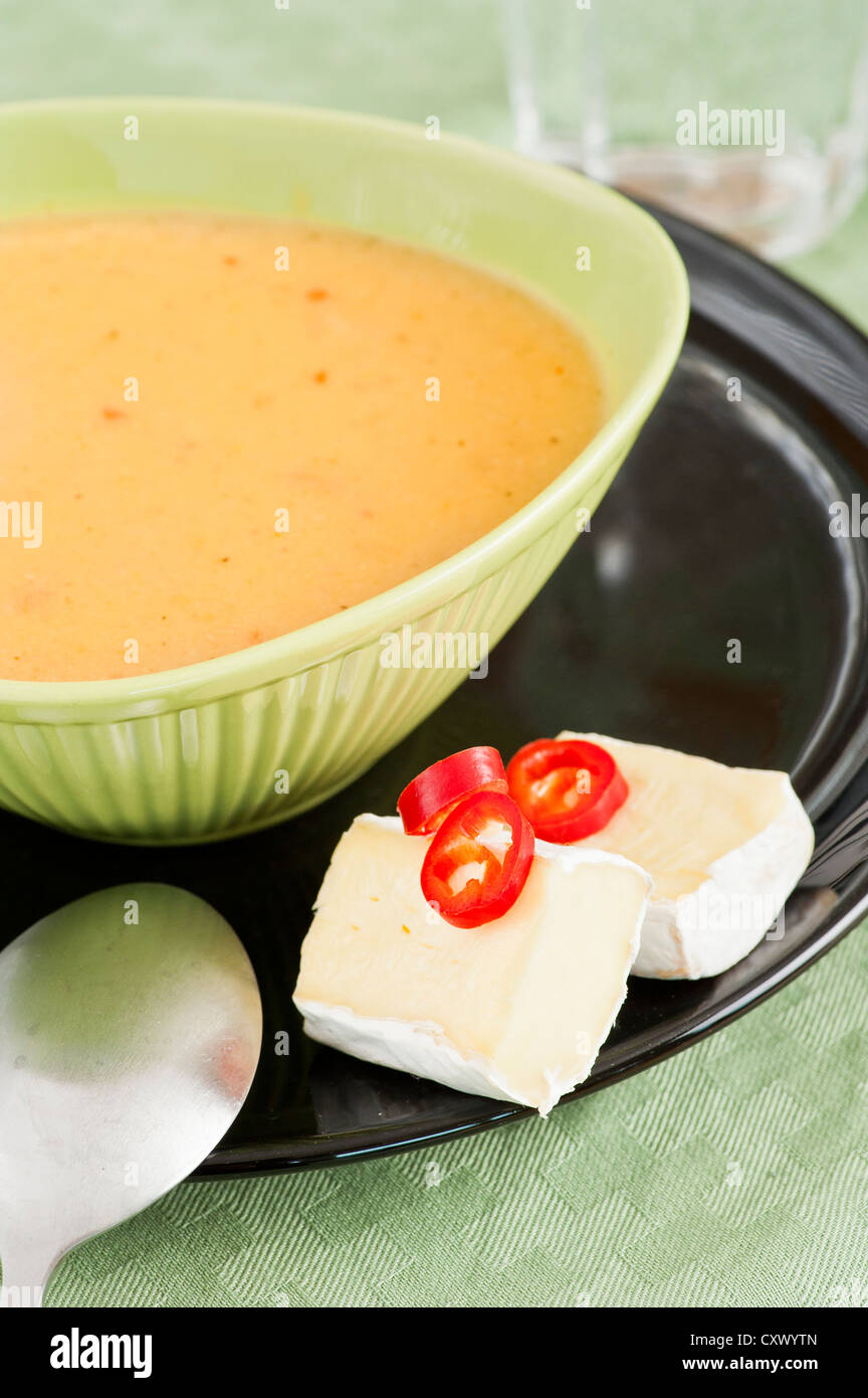 Serving of spicy chilli soup and brie cheesev Stock Photo