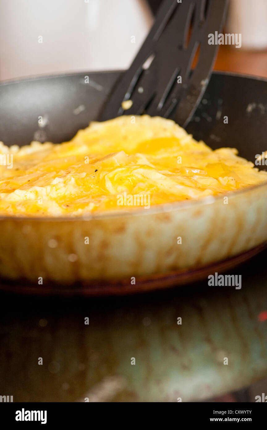 Cooking an omelette on a stove Stock Photo