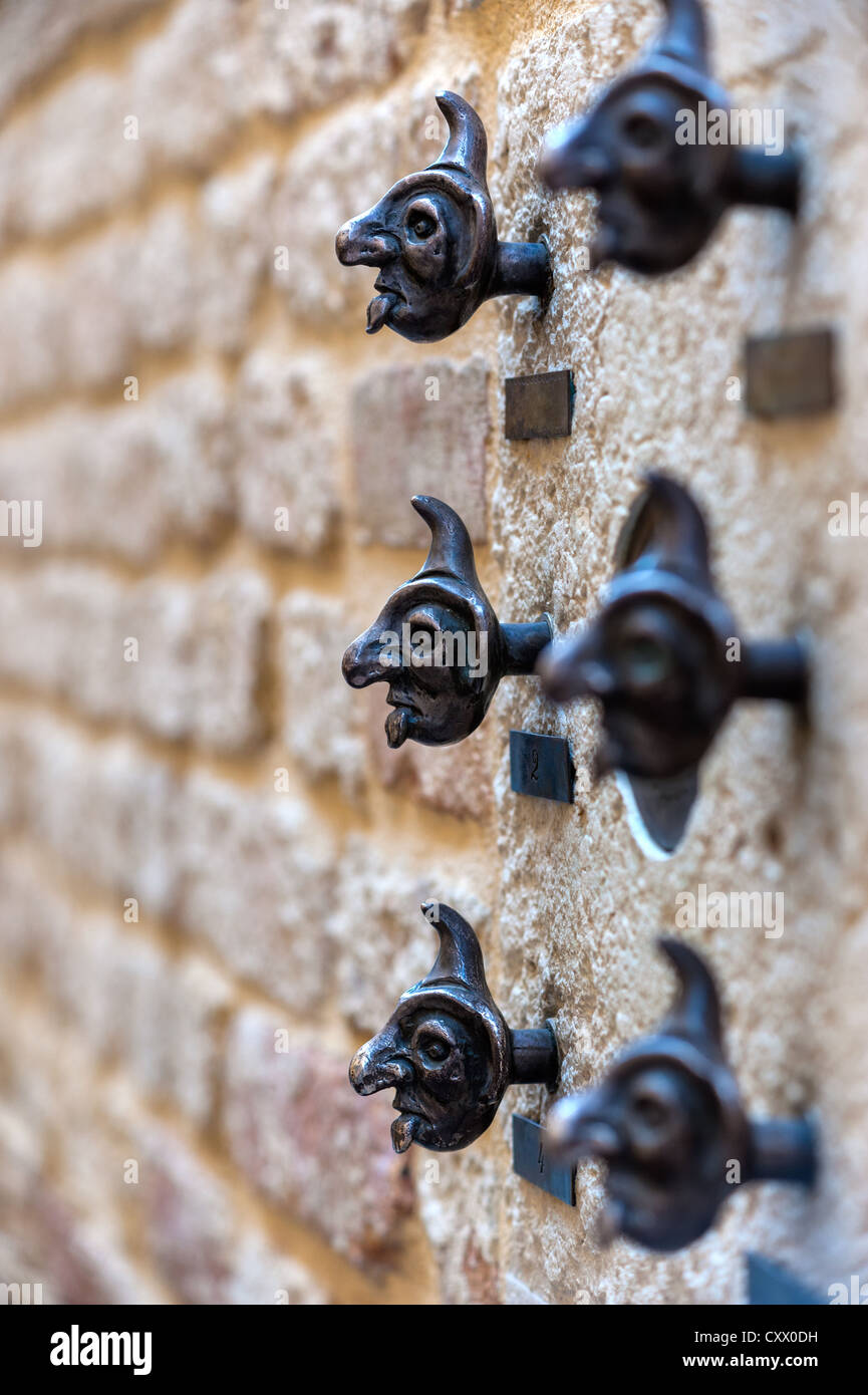 Doorbell buttons in the form of fairy human heads. Shallow depth of field, focus on buttons. Stock Photo