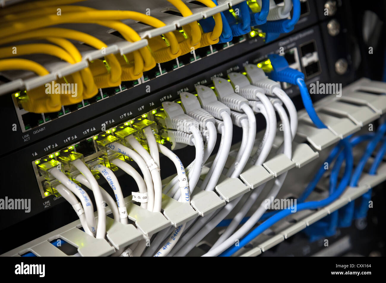 Large network hub and connected Internet cables. Selective focus Stock Photo