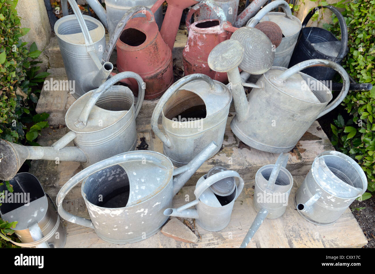 Display of Old Watering Cans Val Joannis Gardens Pertuis Luberon Provence France Stock Photo