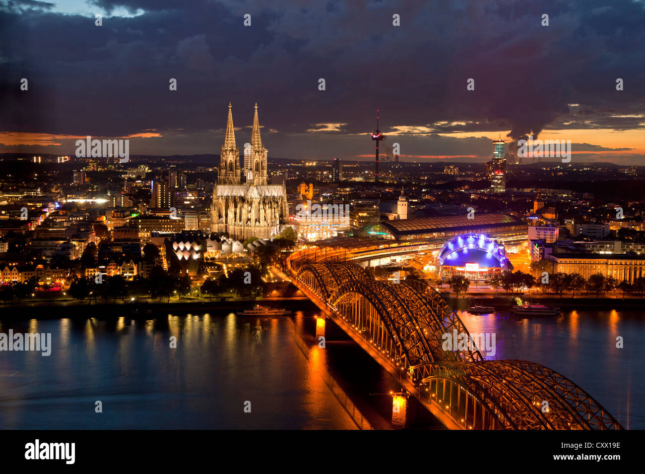 City view of Cologne at night with Cologne Cathedral, Rhine River, Musical Dome and Hohenzollern Bridge, Cologne, Stock Photo