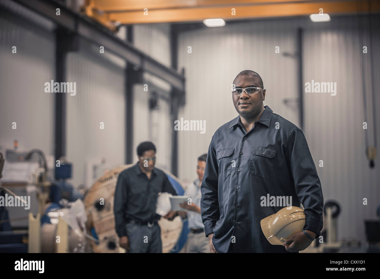 African American worker standing in factory Stock Photo - Alamy