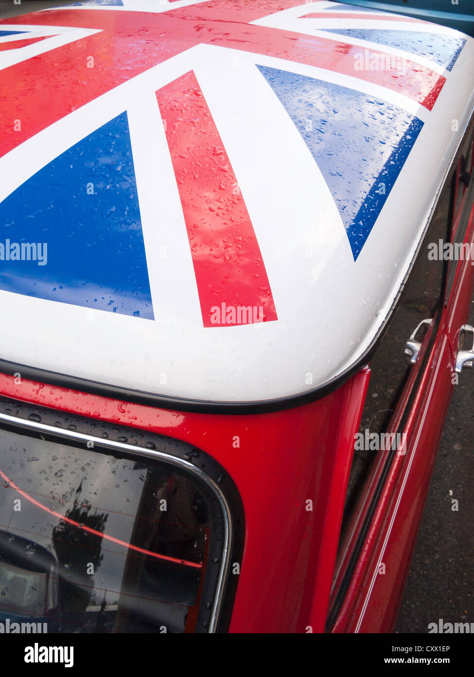 Close up of an historic 1985 red Mini Cooper motor car with a Union Flag painted on its roof Stock Photo