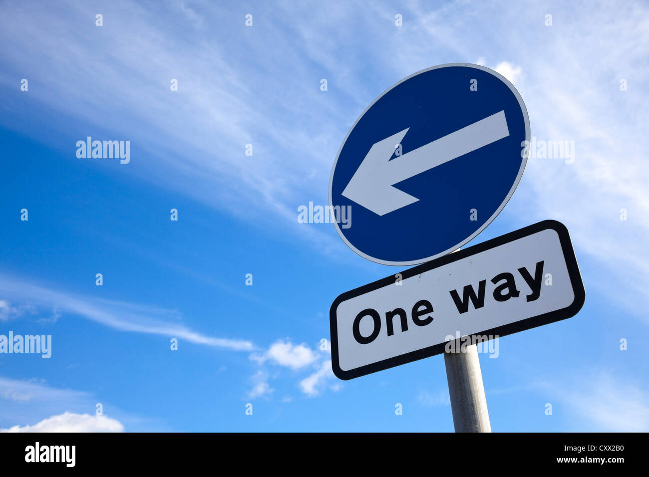 Road sign - One way traffic against blue sky, roads sign UK Stock Photo