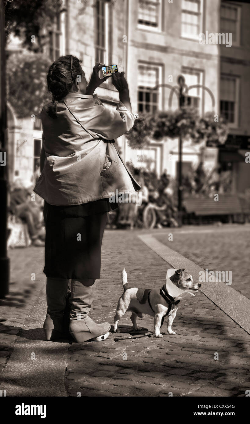 Tourist taking a photo in Truro in Cornwall UK Stock Photo