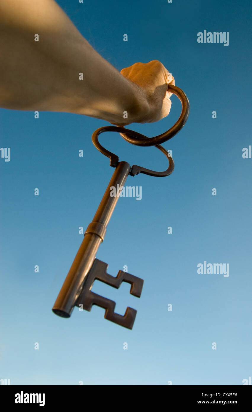Hand Holding up large key.Freedom / Escape concept Stock Photo