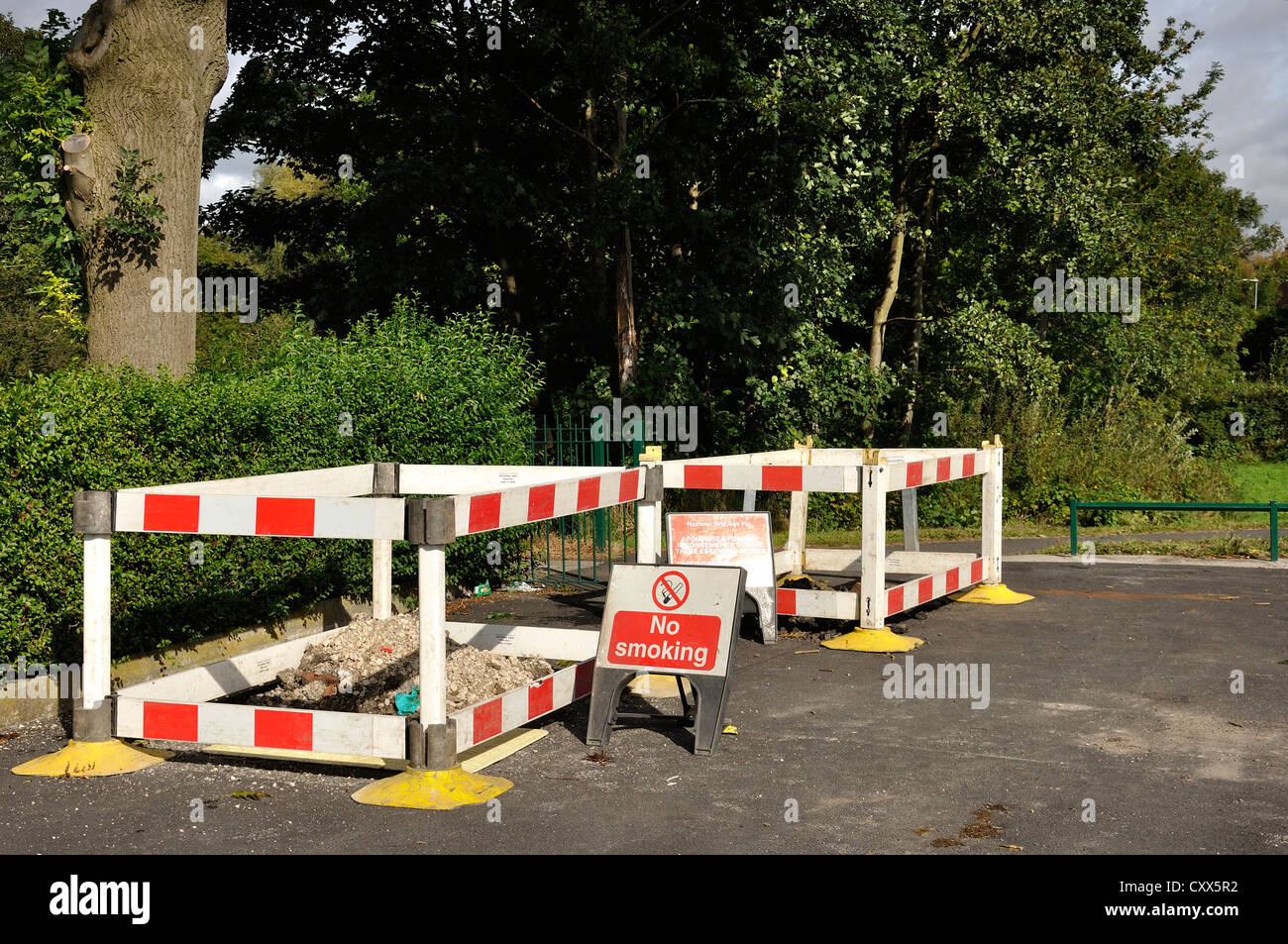 Hazard barrier around work area with no smoking sign displayed Stock