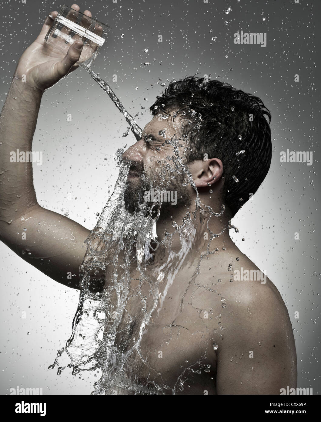 Man pouring water on himself Stock Photo Alamy