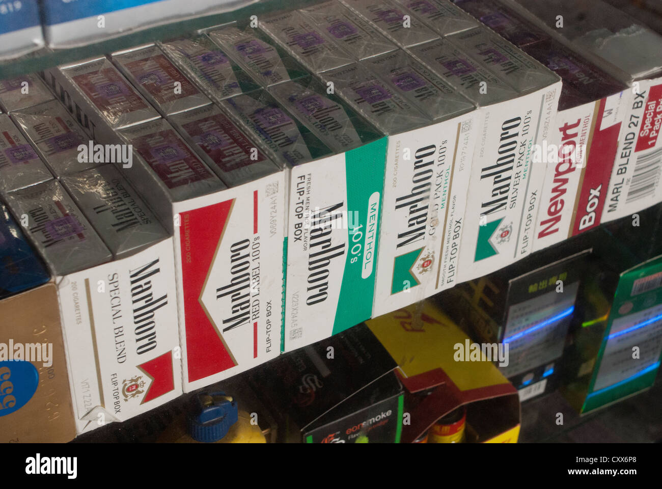 Cartons of cigarettes in the window of a grocery store in New York on Sunday, October 14, 2012. (© Richard B. Levine) Stock Photo