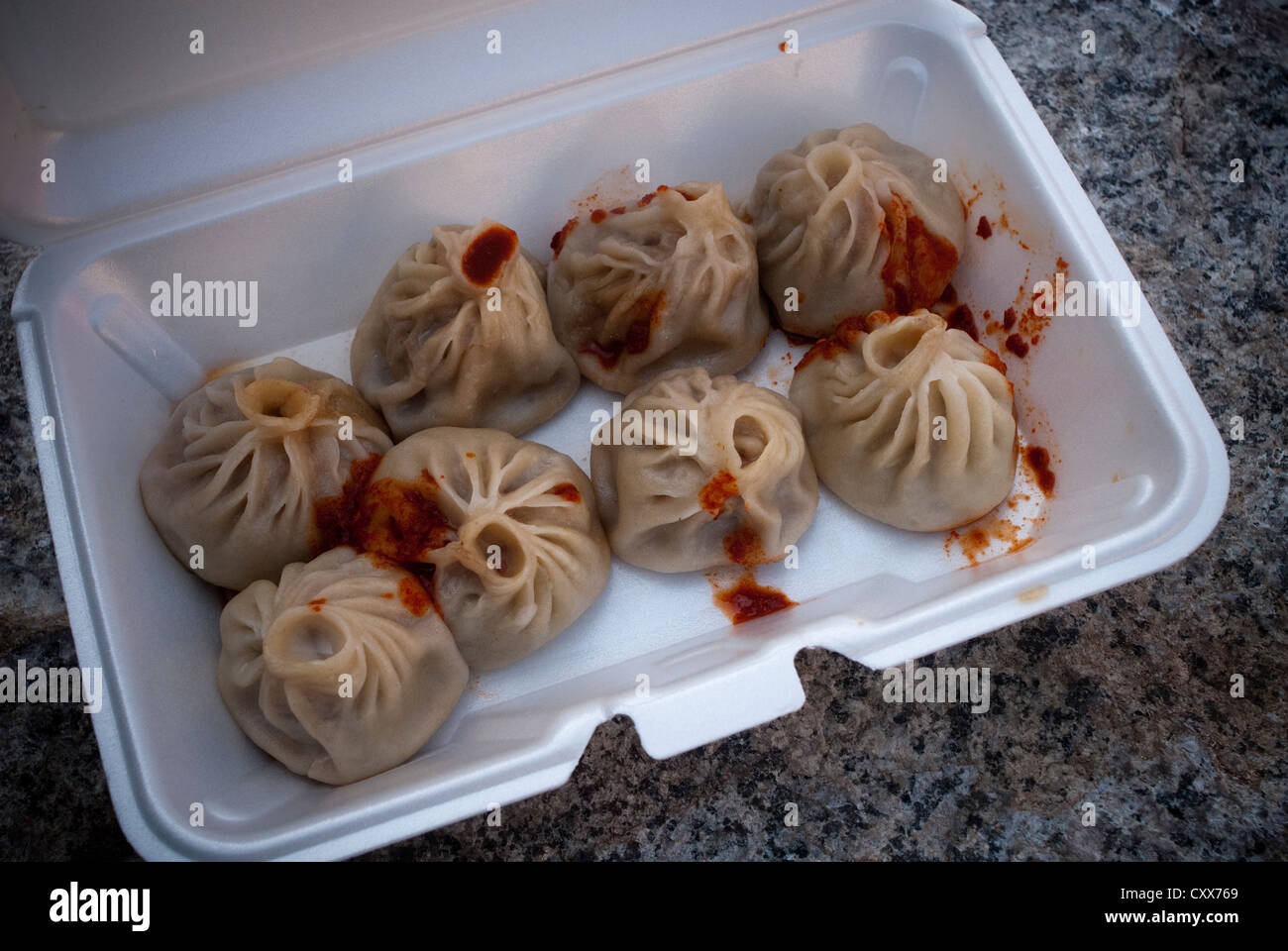Tibetan Momo dumplings with hot sauce in a take out container in New York  on Sunday, October 14, 2012. (© Richard B. Levine Stock Photo - Alamy