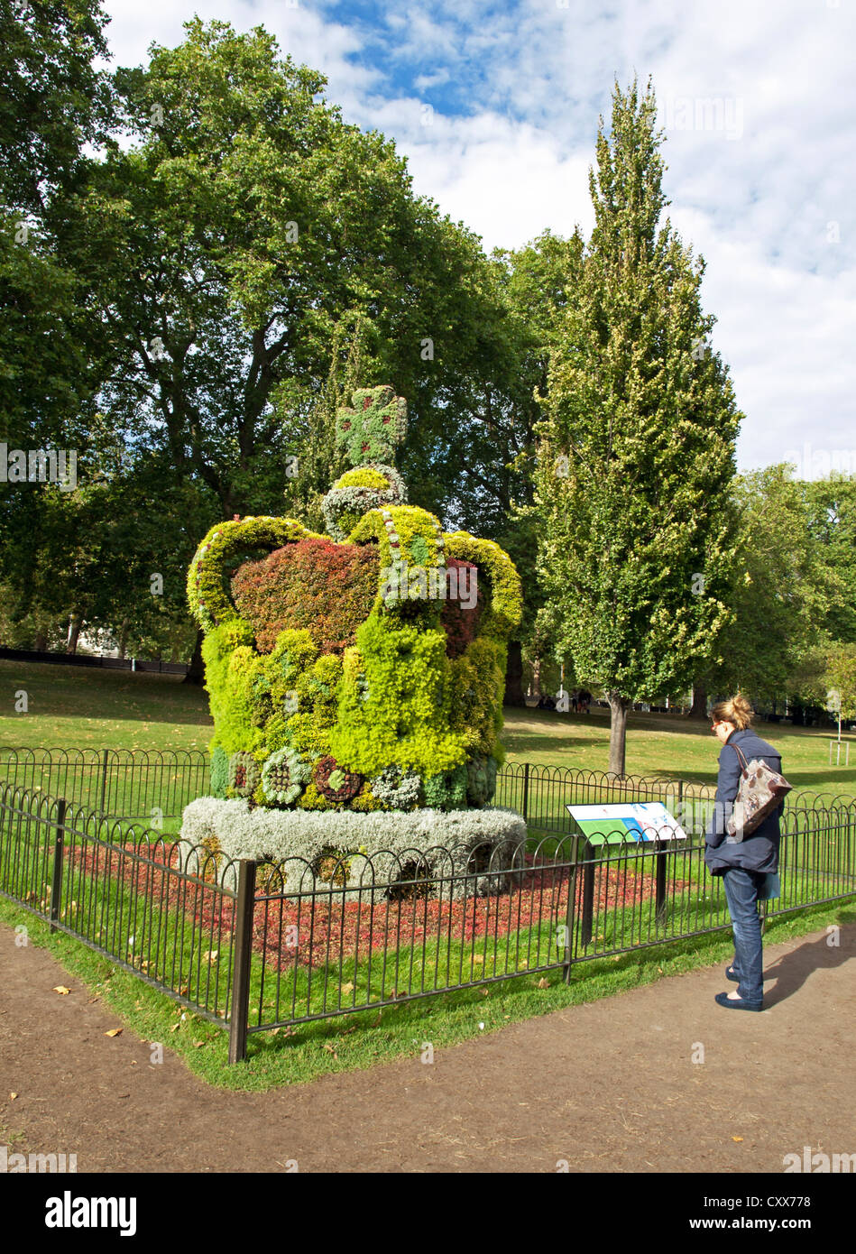 Woman admiring giant floral crown commemorating Queen Elizabeth's Diamond Jubilee, St. James's Park. Stock Photo