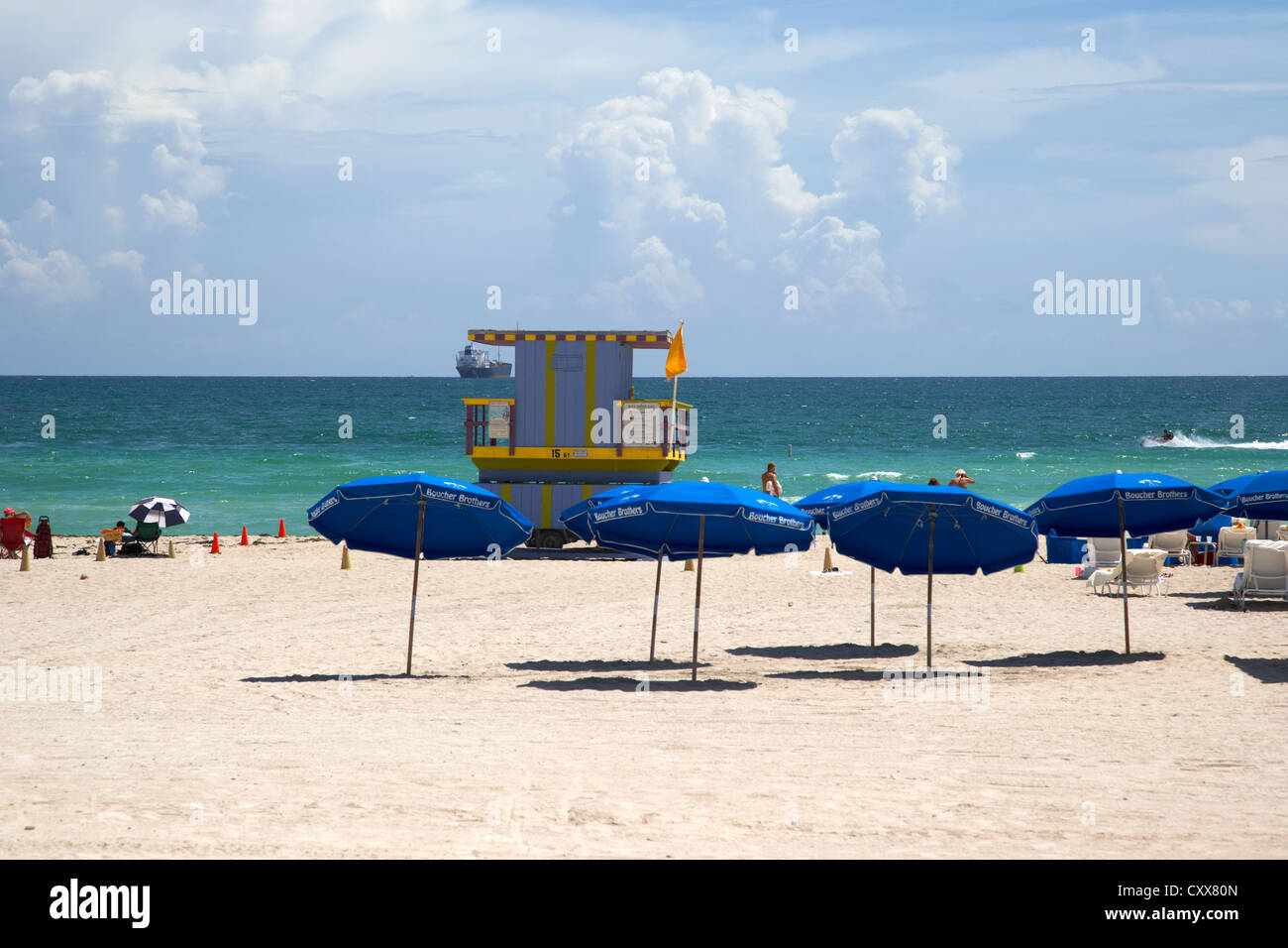 umbrellas and sunshades with lifeguard tower looking out to sea miami