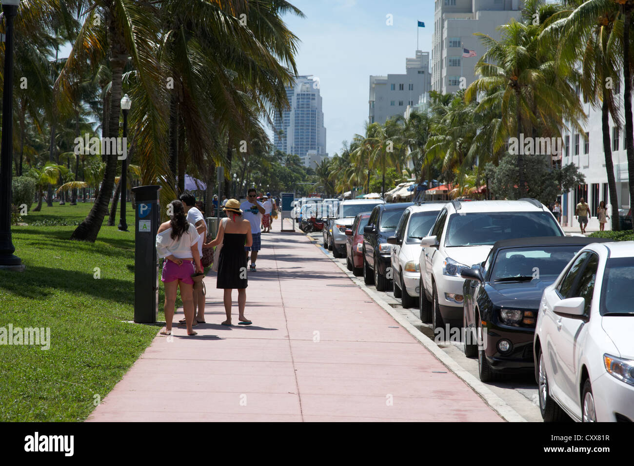 people paying at parking ticket machine ocean drive early morning art