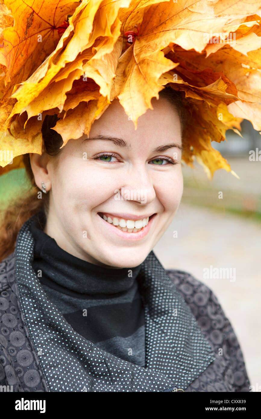 Portrait of happy smiling young woman with maple wreath on head Stock ...