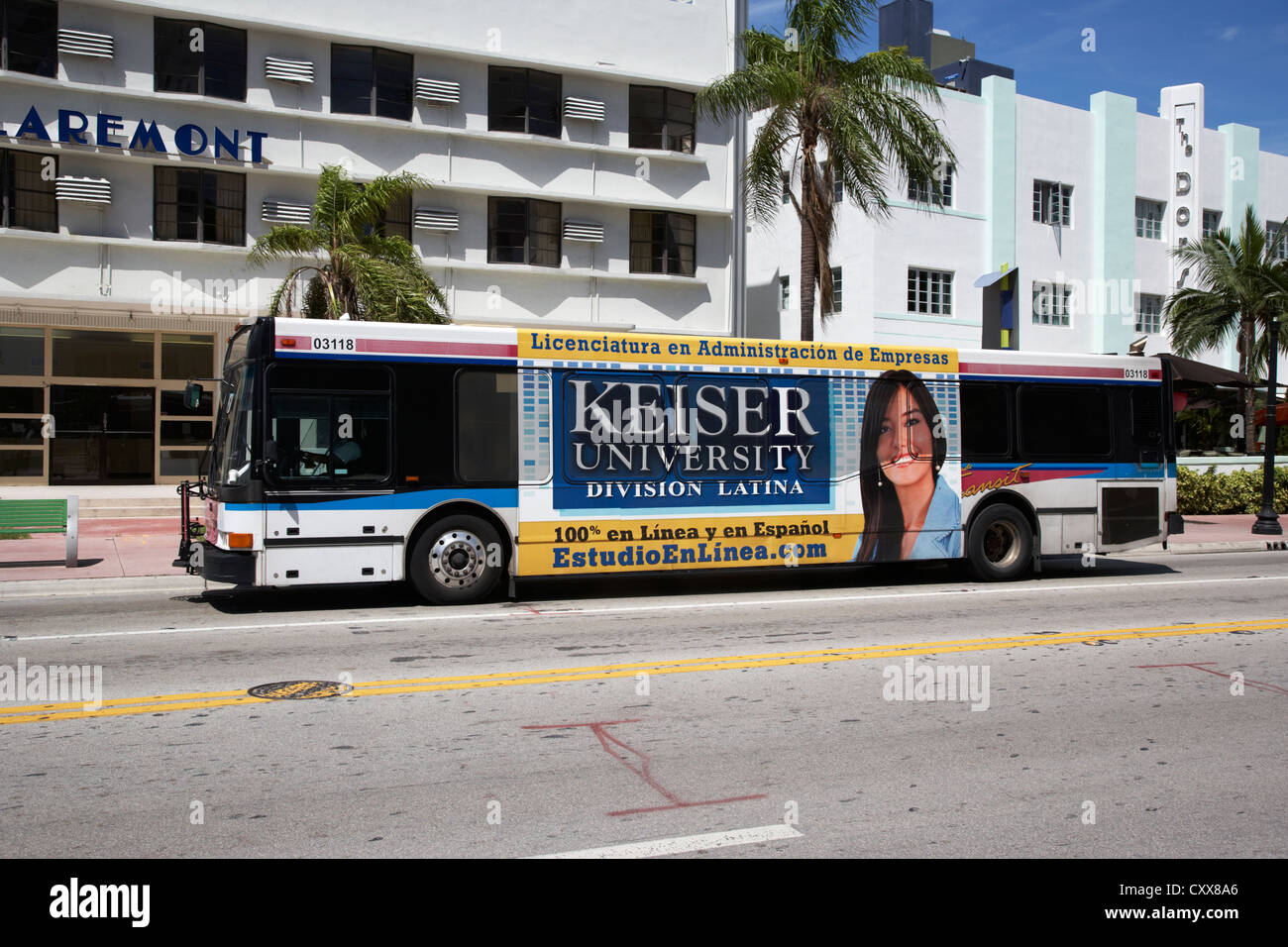 public bus transport with spanish speaking university advert on the side miami south beach florida usa Stock Photo