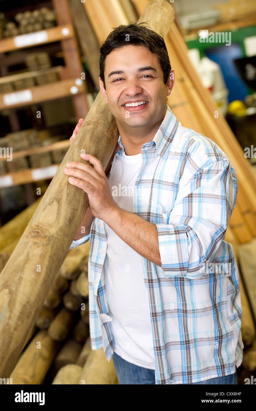 Hispanic carpenter carrying lumber Stock Photo Alamy