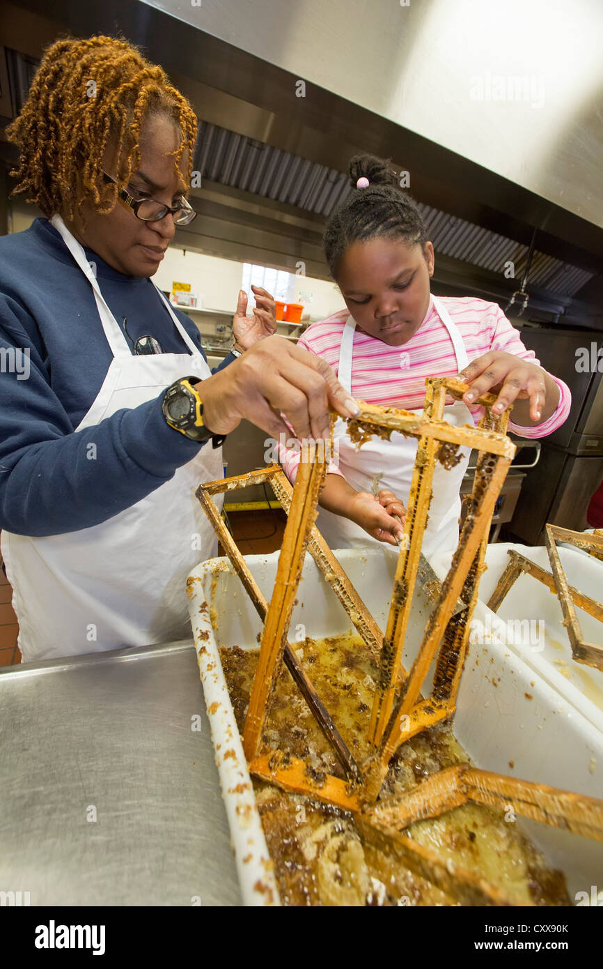 Volunteers clean bee frames after extracting honey at Earthworks Urban