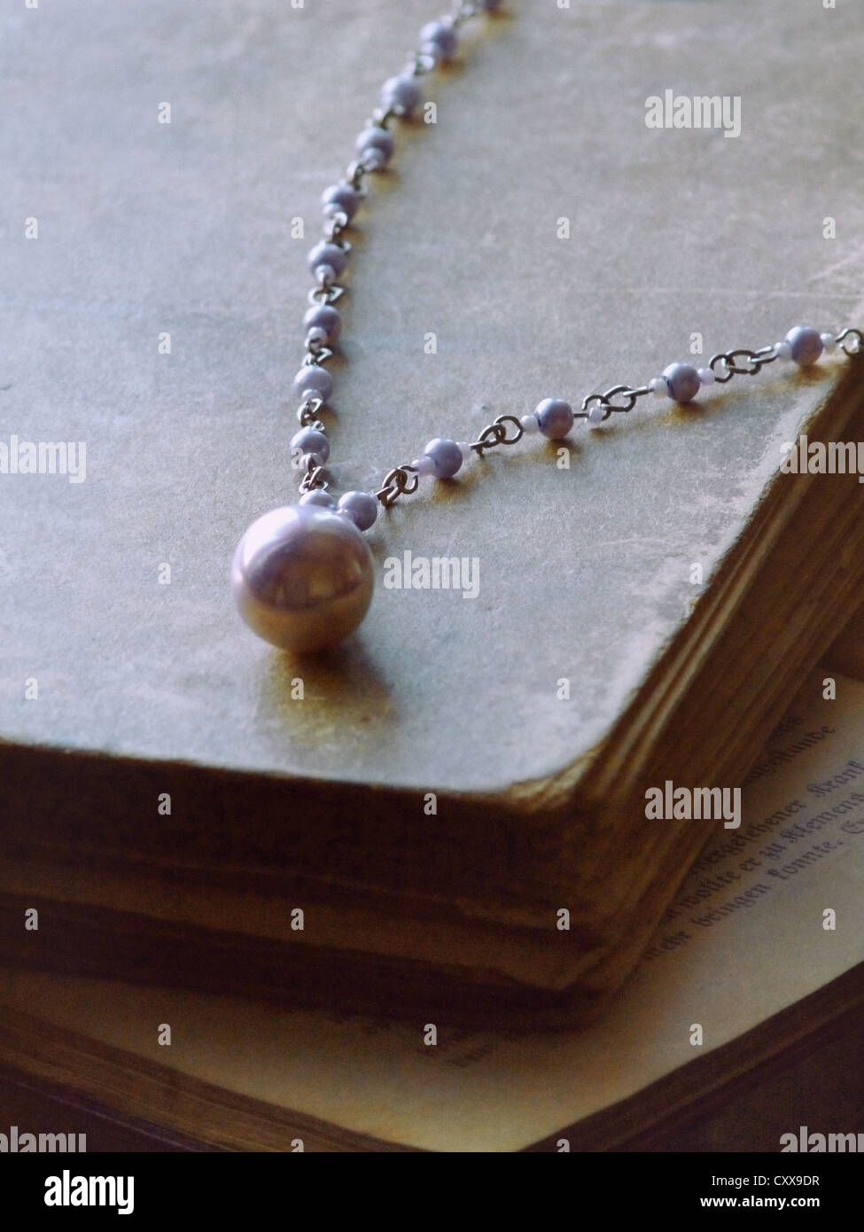 An old large violet pearl necklace laid 