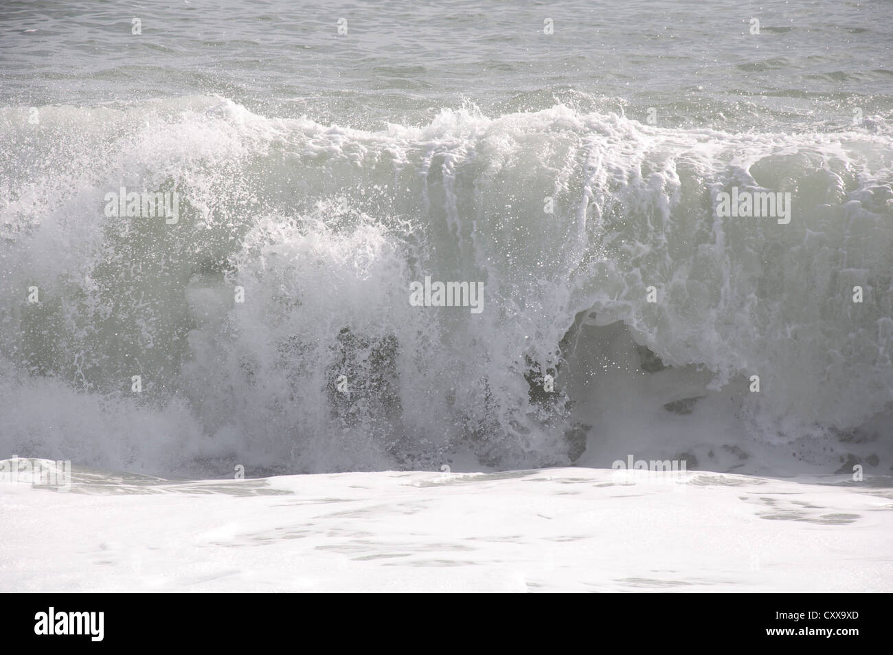 A big wave breaking upon Chesil Beach, on the Dorset coast, during