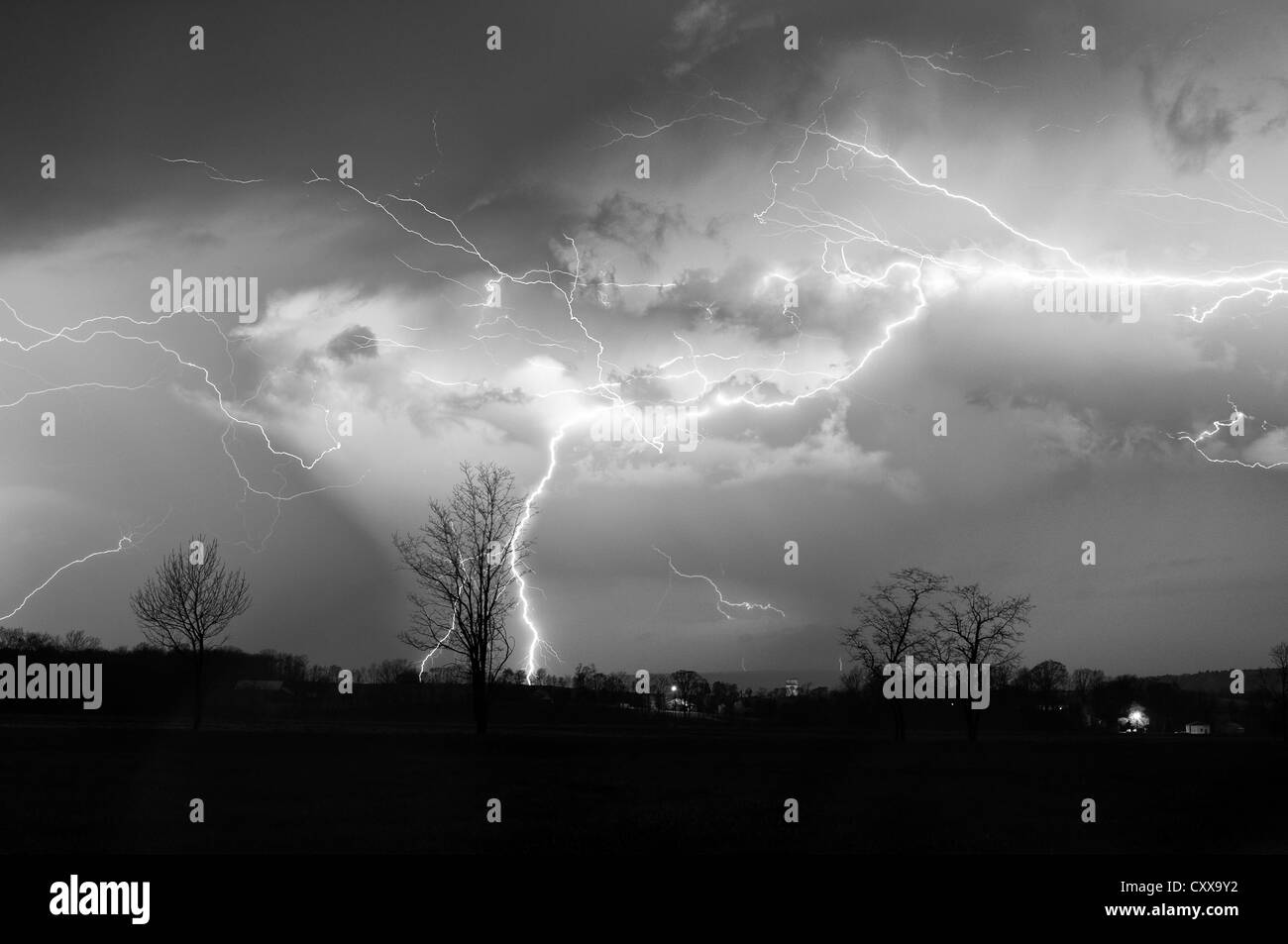 A composite image of lightning strikes over a field. Stock Photo
