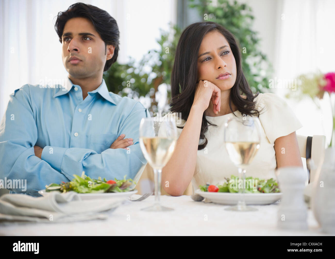 Unhappy mixed race couple dining together Stock Photo