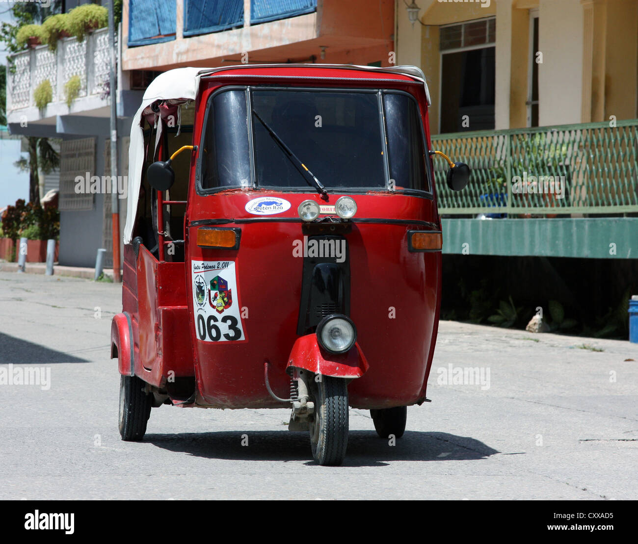 Bajaj Tricycle motor rickshaw taxi races through the picturesque streets of Flores, Guatemala Stock Photo