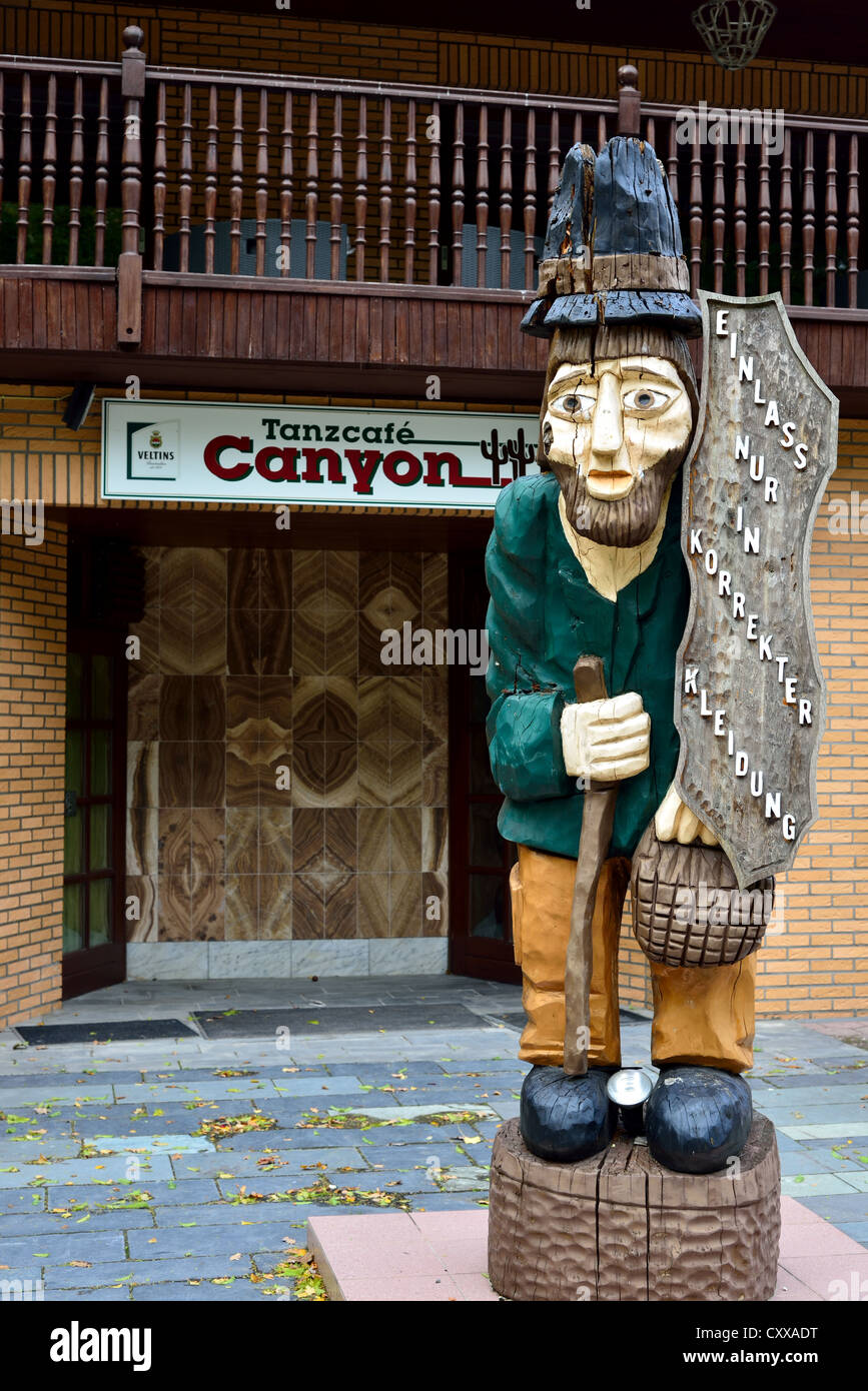 A wood carved figure in front of a guesthouse. Bad Betheim, Germany. Stock Photo