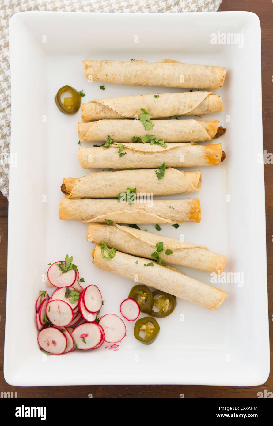 Mexican taquitos on platter Stock Photo Alamy