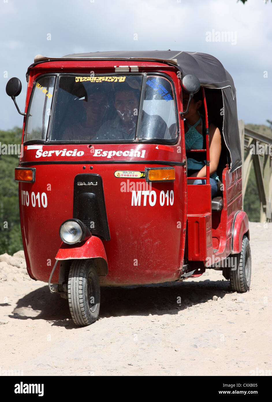 Bajaj Tricycle motor rickshaw taxi races towards San Marcos, Honduras Stock Photo