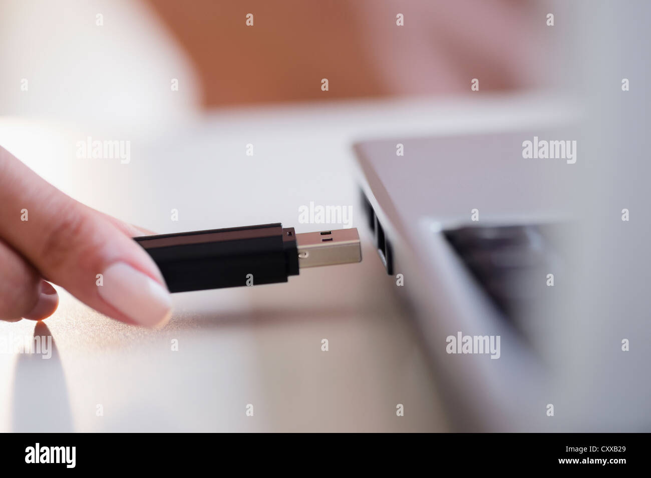 Cape Verdean woman using USB device Stock Photo