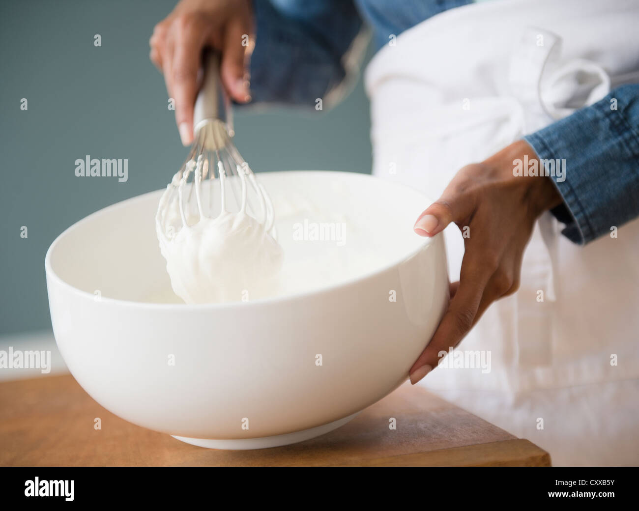 Cape Verdean woman whisking cream Stock Photo