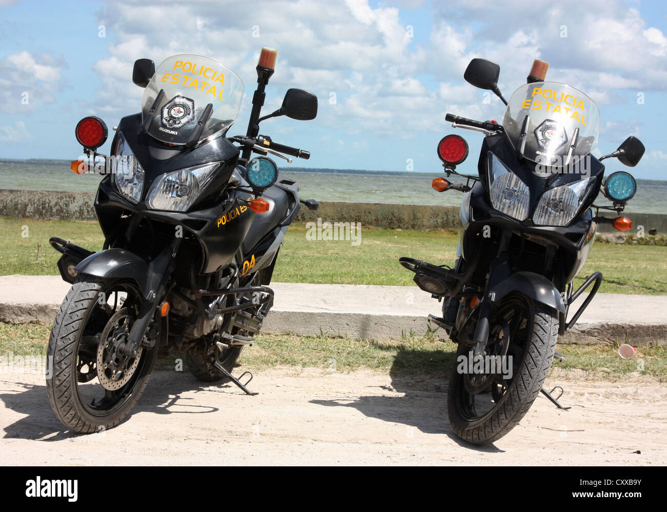 Mexican police motorcycles parked next to the Caribbean sea in Corozal, Belize Stock Photo