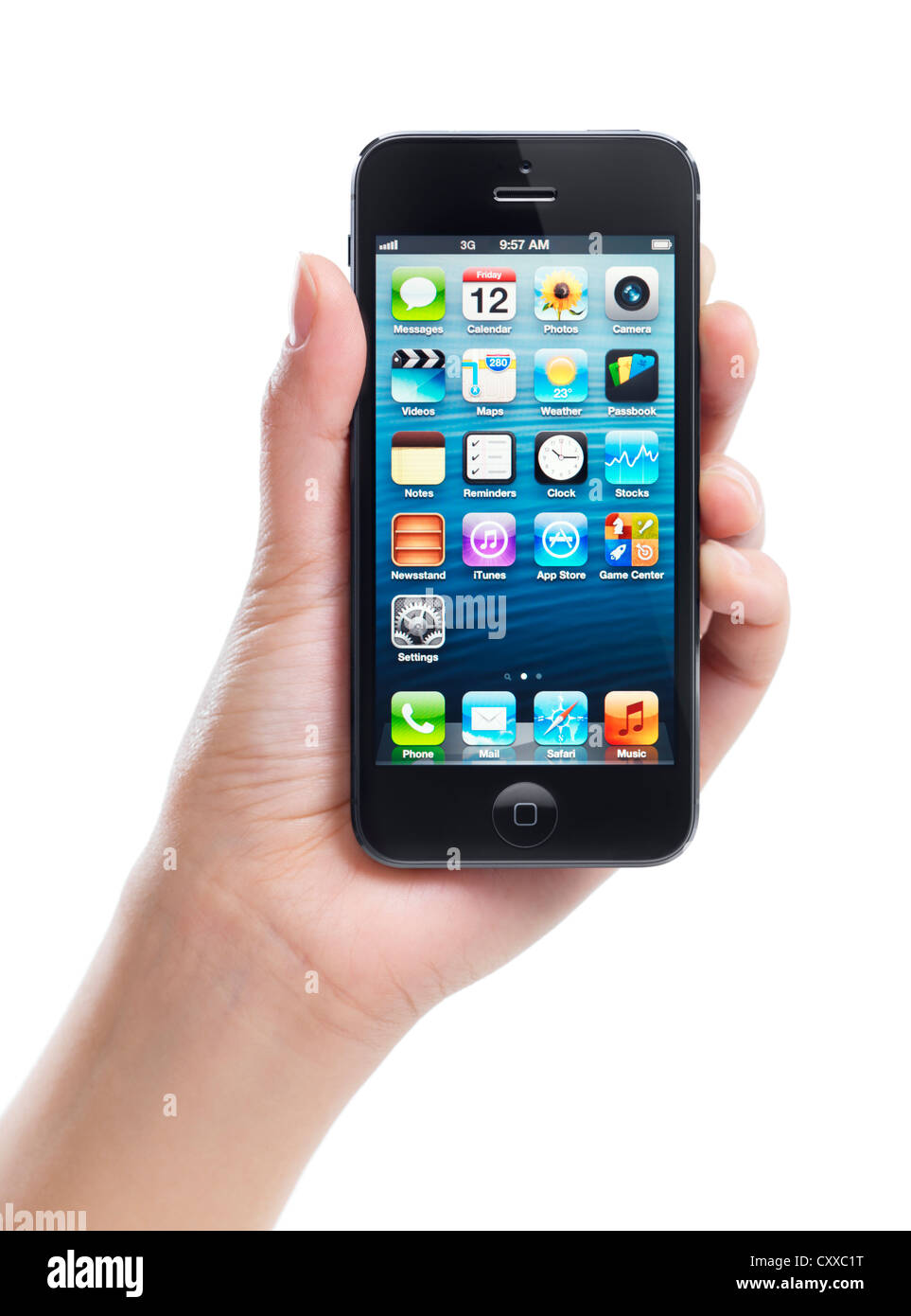 Hand holding Apple iPhone 5 black with blue desktop on its display isolated on white background Stock Photo