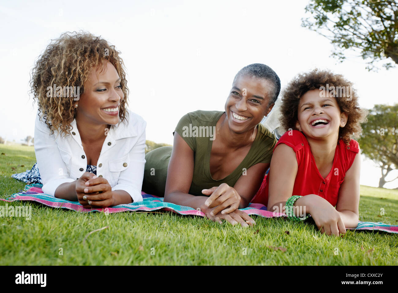 African American family laying on grass in park Stock Photo - Alamy