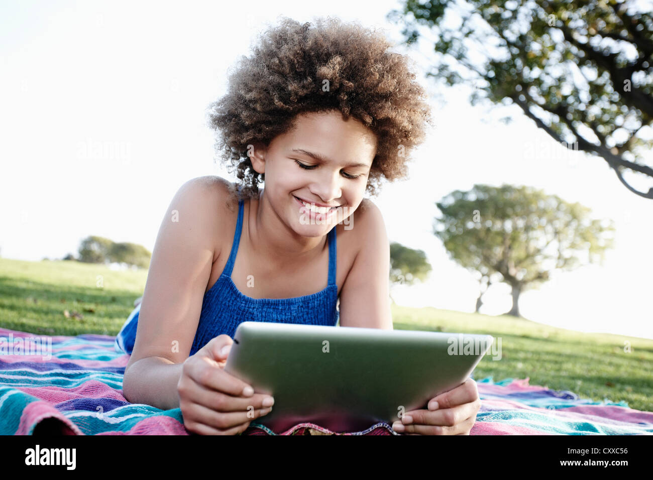 Girl using tablet in park hi-res stock photography and images - Alamy