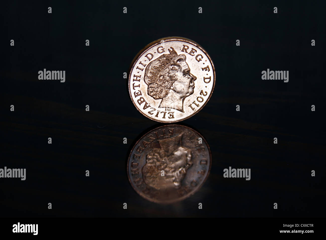 2 pence, two pence shiny coin on a high reflective black surface Stock Photo